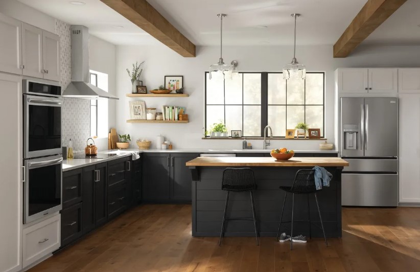 Stainless steel appliances in a kitchen with blue cabinets