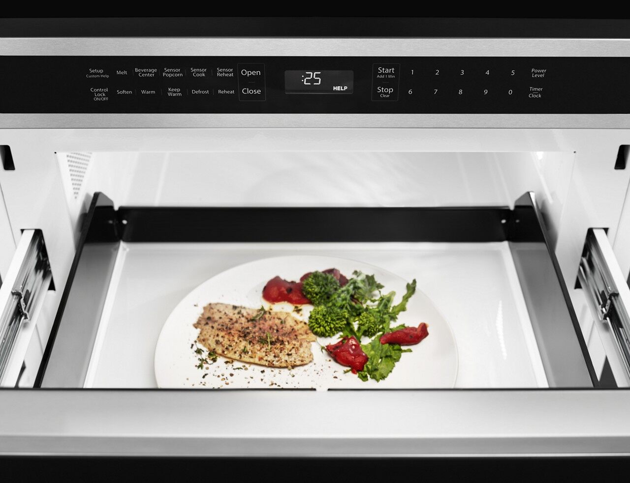 Fish and vegetables inside of a microwave drawer 