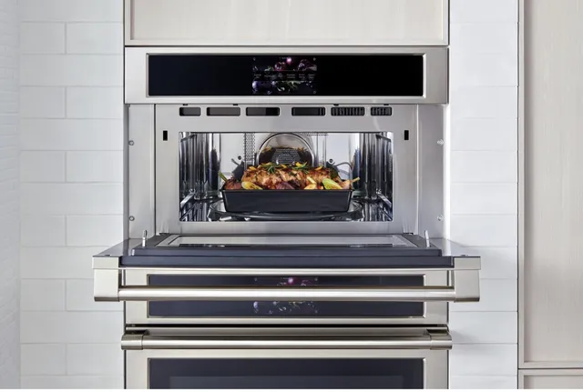 The Monogram ZSB9132NSS speed oven with its door open revealing a roast 