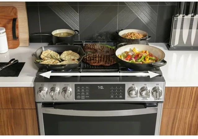 Depiction of five burner gas range with griddle fully occupied 