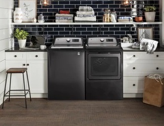 GE GTW720BPNDG top load washer with matching dryer in laundry room