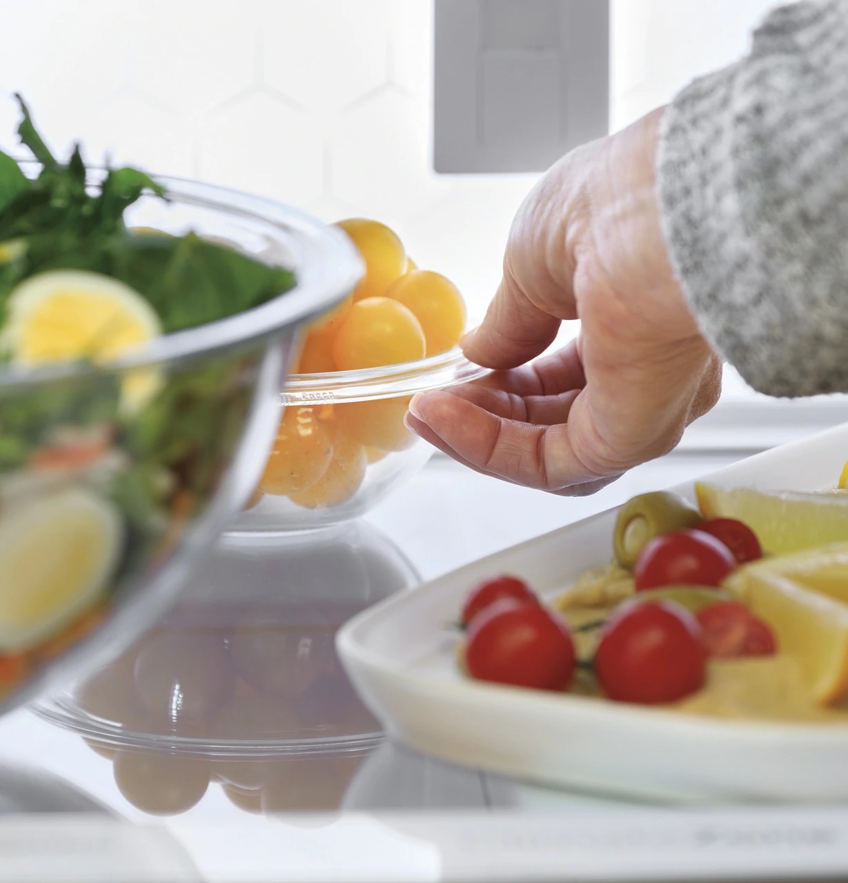 woman grabbing produce using ge profile PVD28BYNFS LED light wall