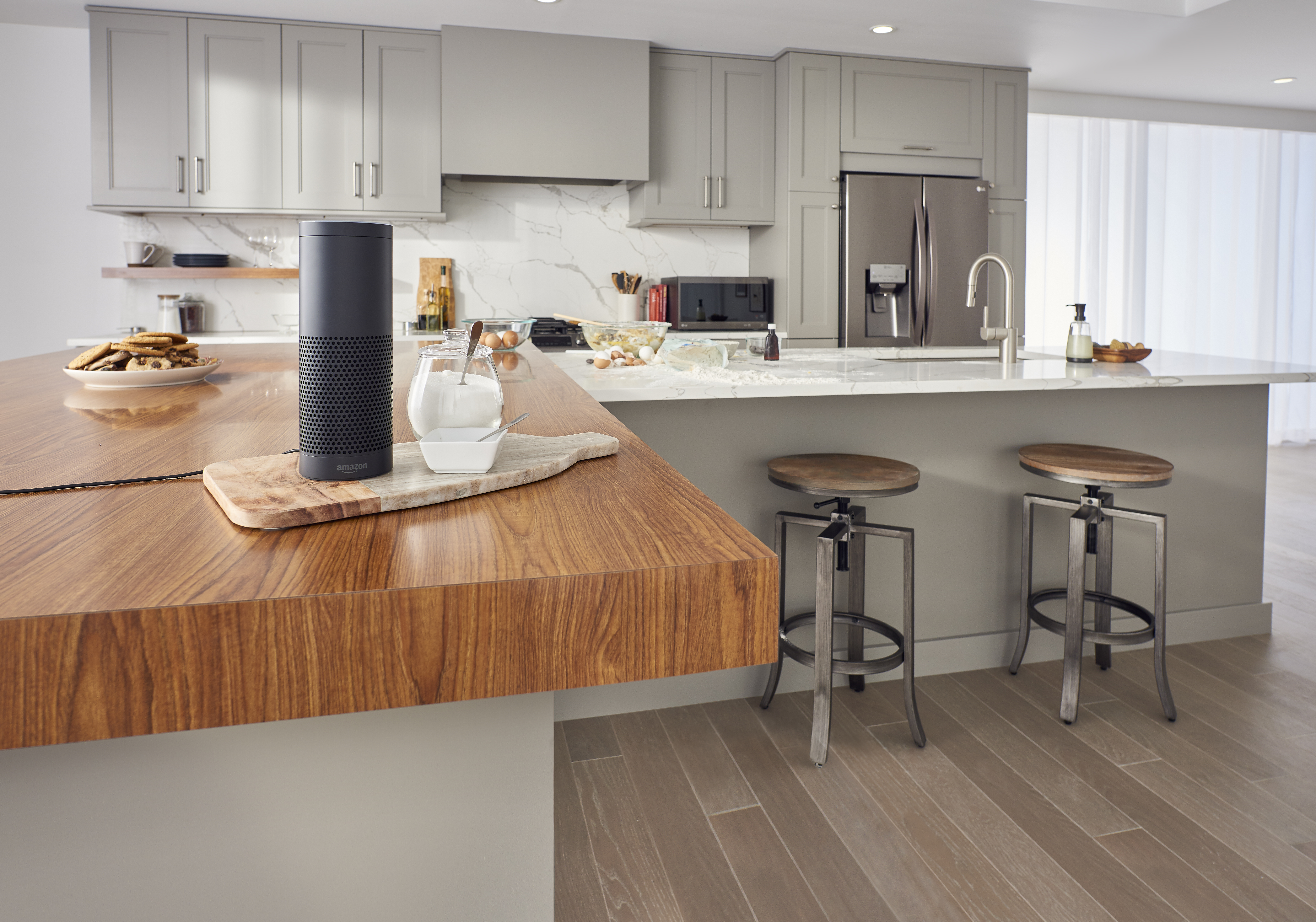 Wide shot of kitchen with smart assistant in the foreground