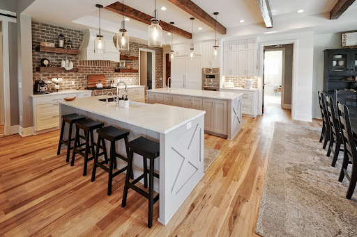 Wide shot of JFK Design Build’s Delafield double island kitchen featuring a Thermador speed oven 