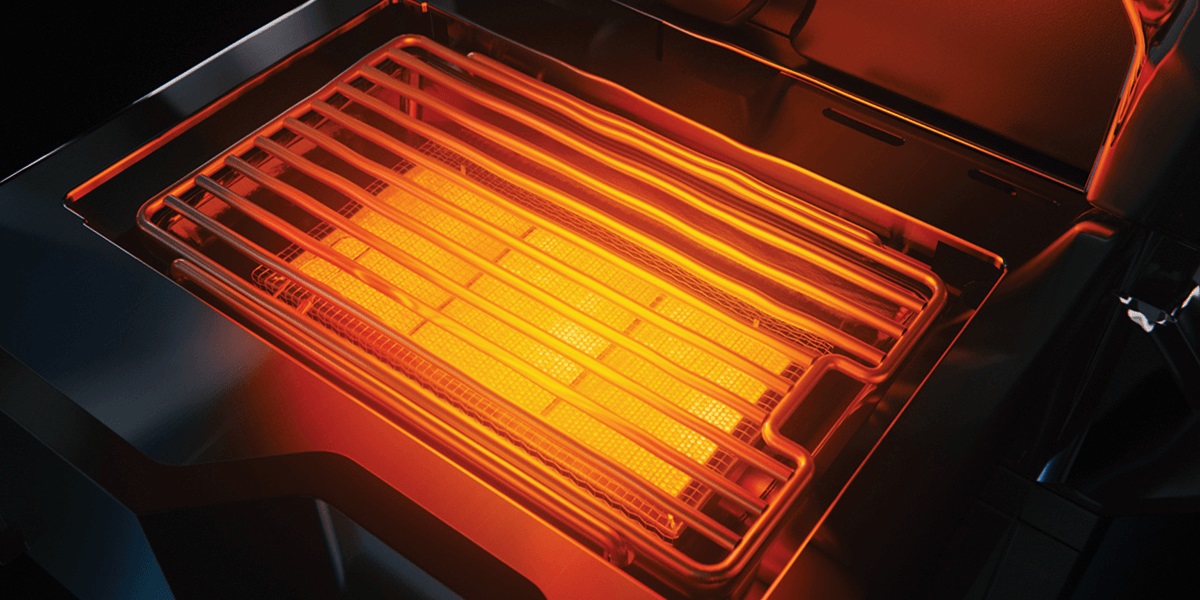 Napoleon grill burner shown ignited 
