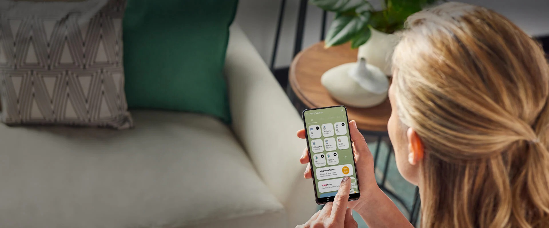 Woman using the LG ThinQ Care app on her smart device