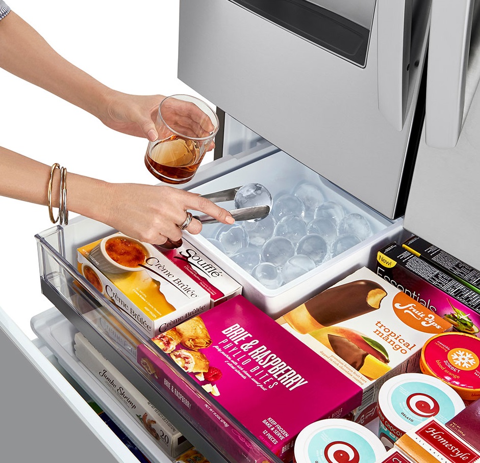 Person grabbing Craft Ice from inside the LG LRFXC2416S French door refrigerator freezer 