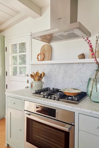 Bosch gas cooktop, wall oven, and canopy hood featured in Teri Fisher's renovated ranch-style kitchen