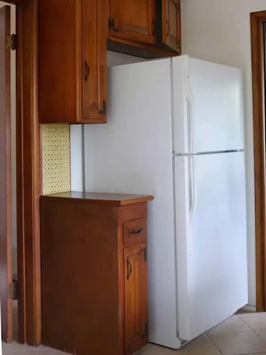 Old corner of Teri Fisher Bosch ranch-style kitchen remodel with a top-freezer refrigerator