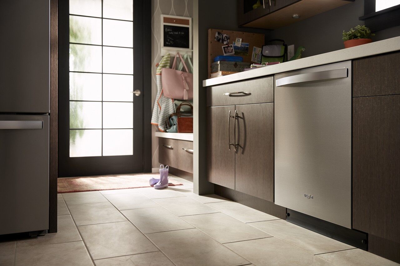 built in whirlpool dishwasher in modern wooden kitchen