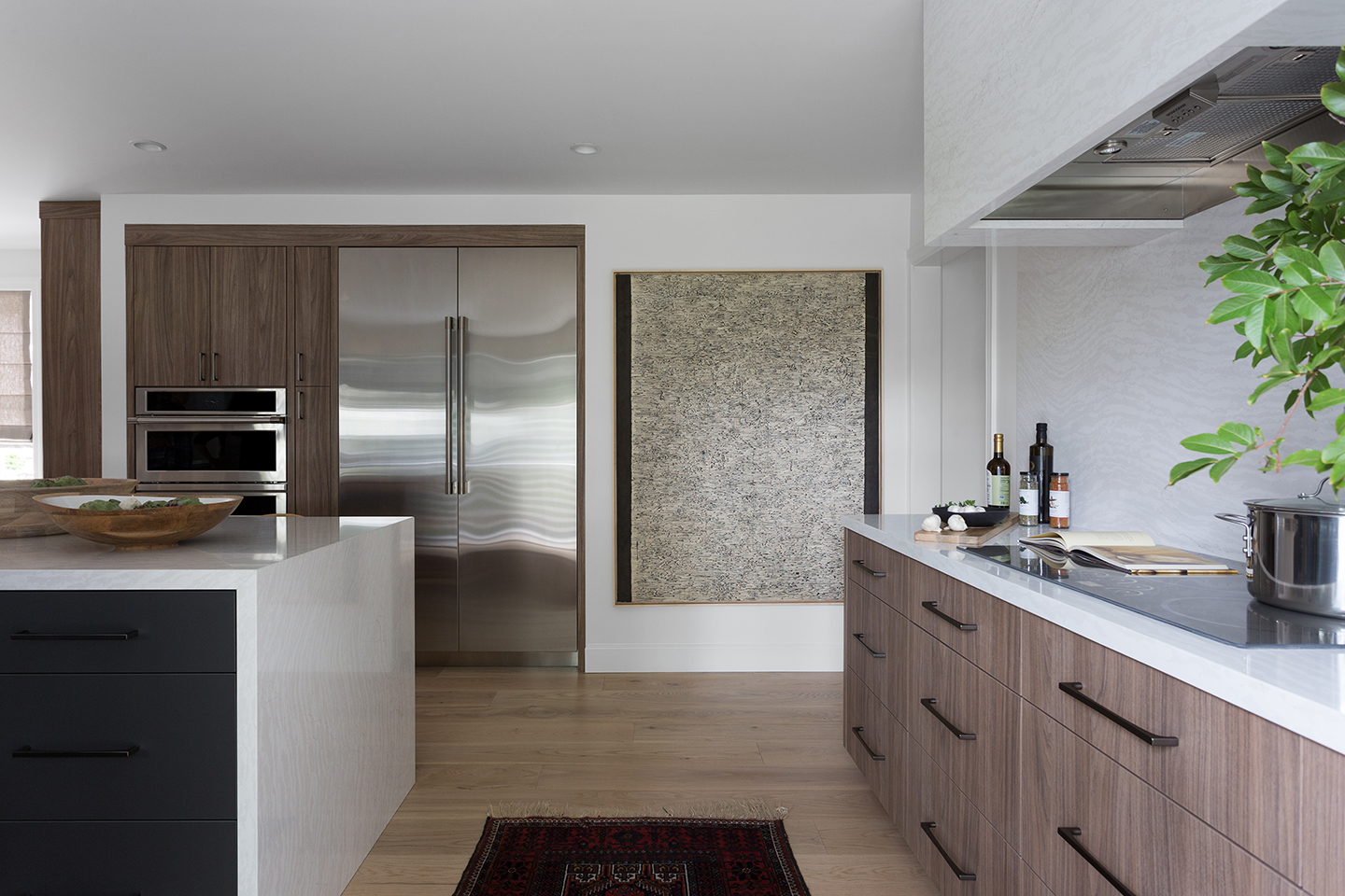 A monogram refrigerator and freezer column showcase behind two kitchen islands