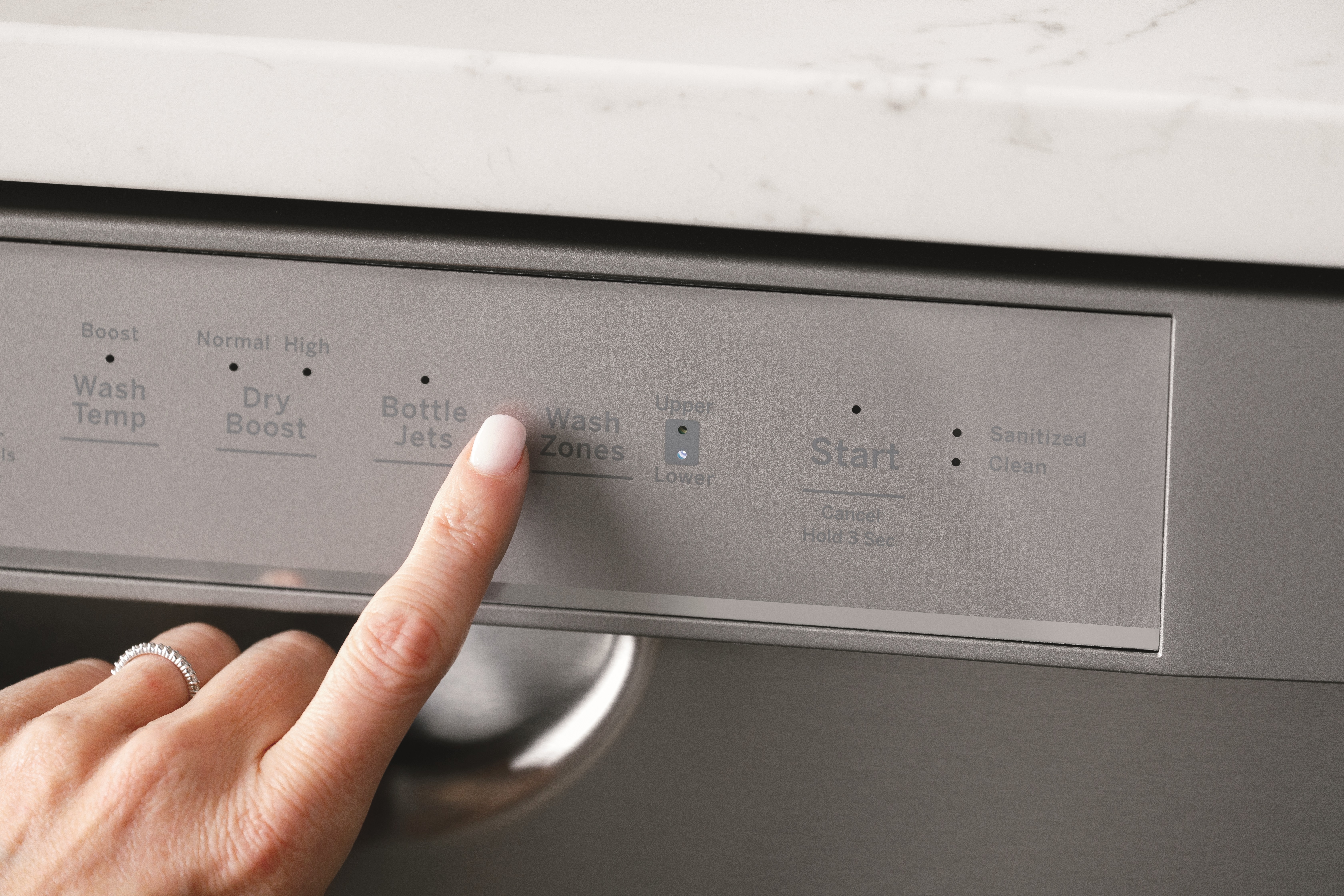 Close up of user selecting a wash cycle on a GE front control dishwasher 