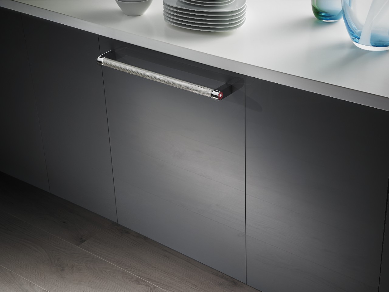 Side view of KitchenAid panel-ready dishwasher in black finish with towel bar handle 