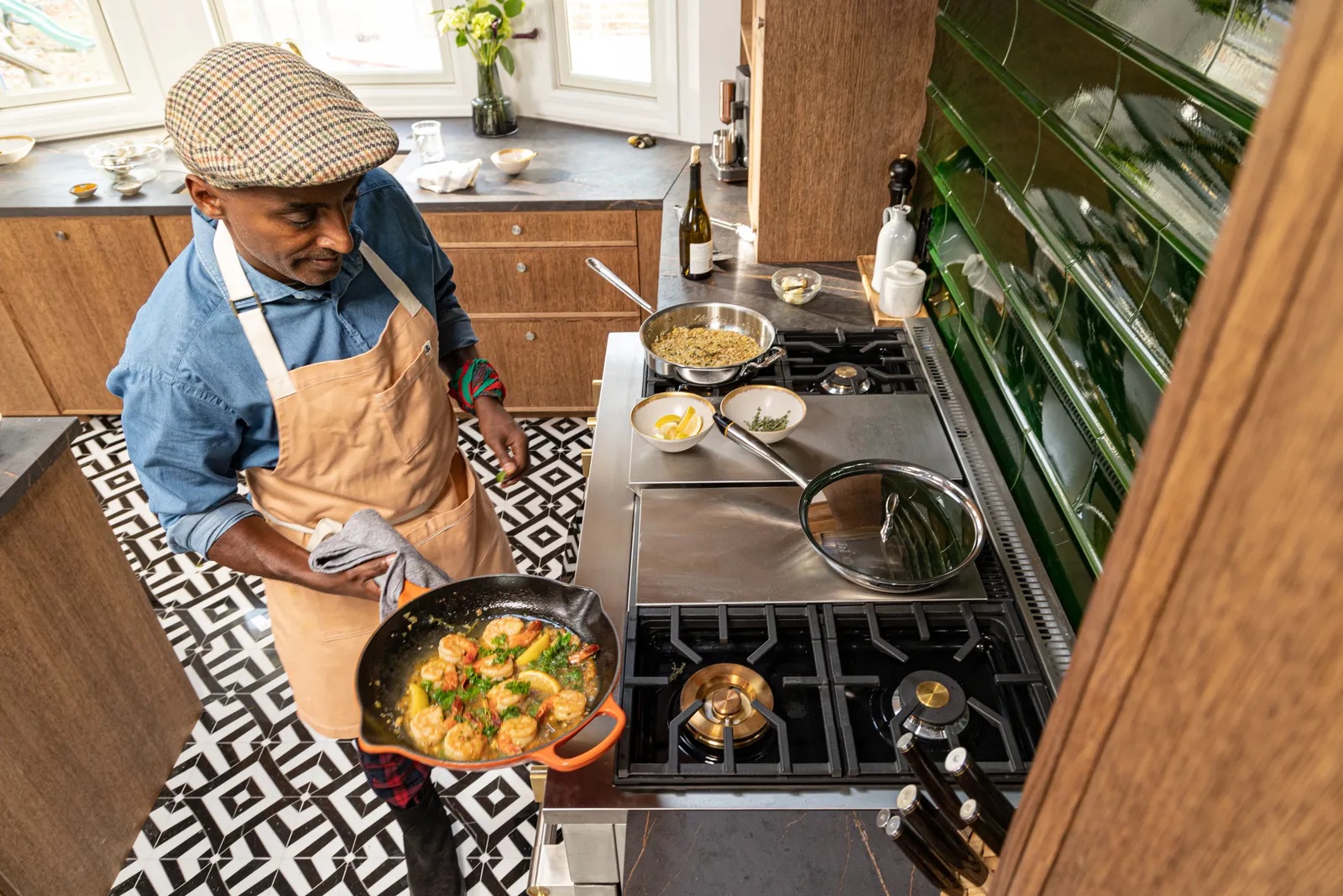 Marcus Samuelson shown cooking several dishes on a Monogram 48” dual-fuel range 