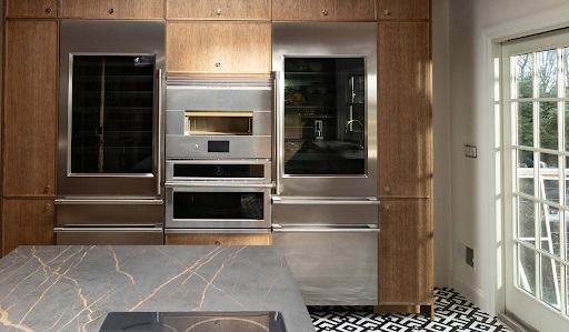 Two Monogram wine coolers flanking a Monogram speed oven and Monogram hearth oven 