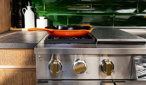 Up close look at Monogram professional range with an orange cast iron pot