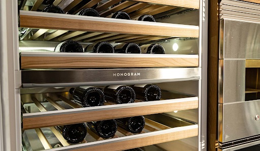 Up close look at several racks of wine inside a Monogram built-in wine cooler 