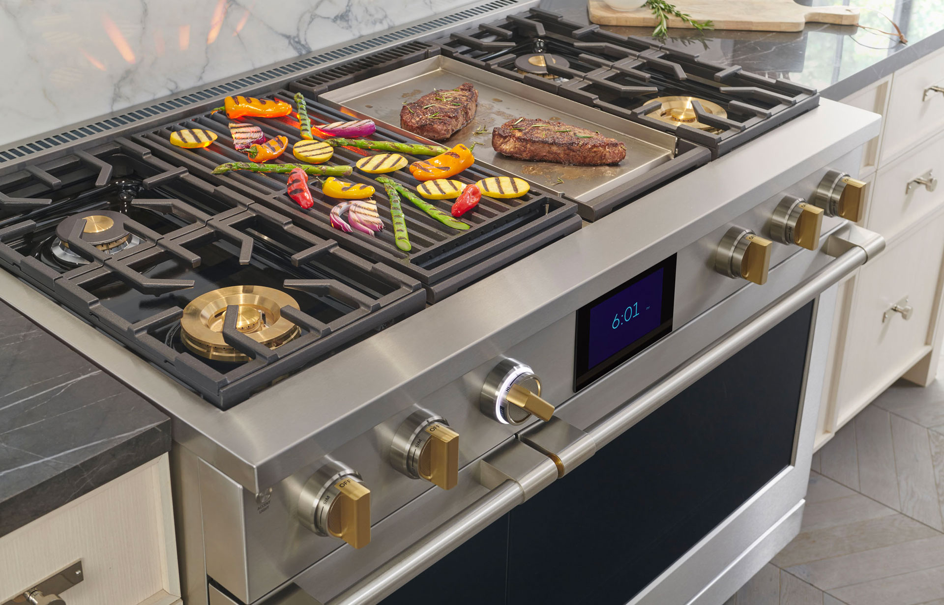 View of Monogram 48-inch range with several items cooking on the cooktop 