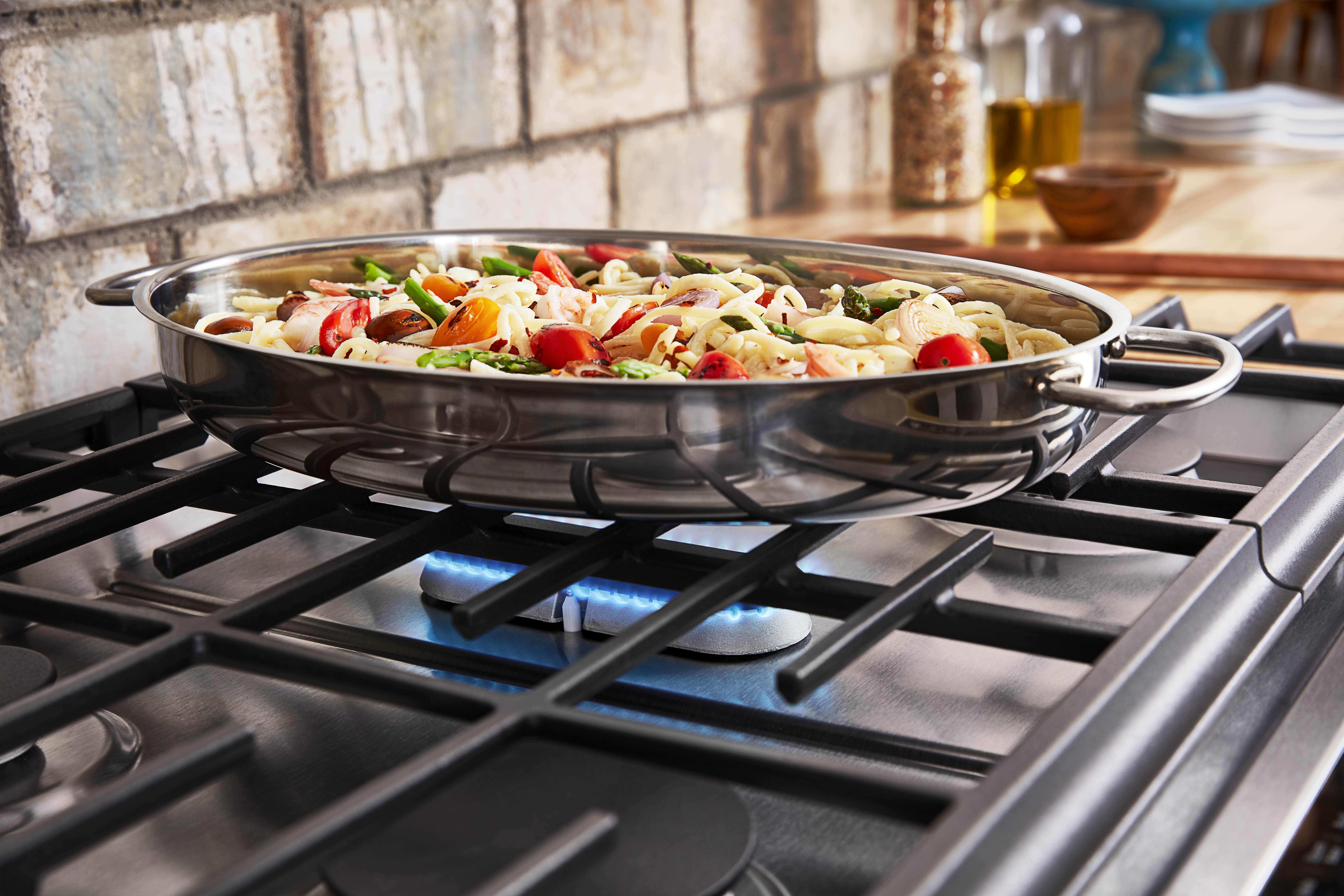 Whirlpool product image of oval center burner cooking vegetables cooking inside oval pan