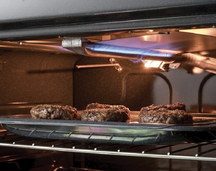 Hamburgers grilling under GE jgss66selss gas range oven broiler 