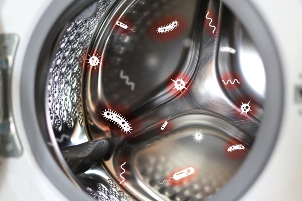 bacteria icons coming out of a front load washing machine