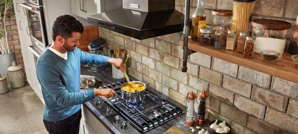 KitchenAid Cooktop Cooking Man Cooking on Gas KitchenAid Cooktop