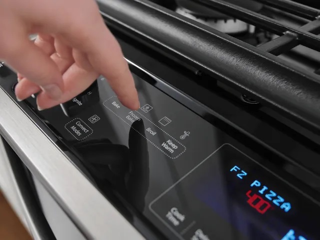 Person selecting Frozen Bake option on Whirlpool WEG745H0FS range
