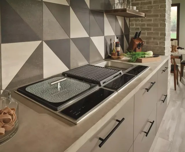 Wide shot of Wolf module cooktops including steamer