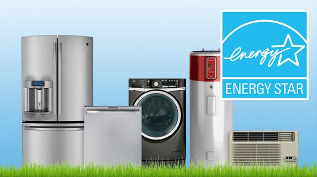 front view of various home appliances in front of a blue background on top of grass, with a large "ENERGY STAR" logo in the top right