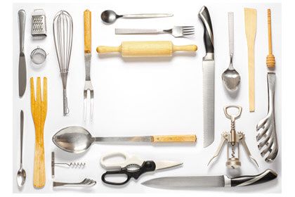 aerial view of various kitchen gadgets laid out on a white surface