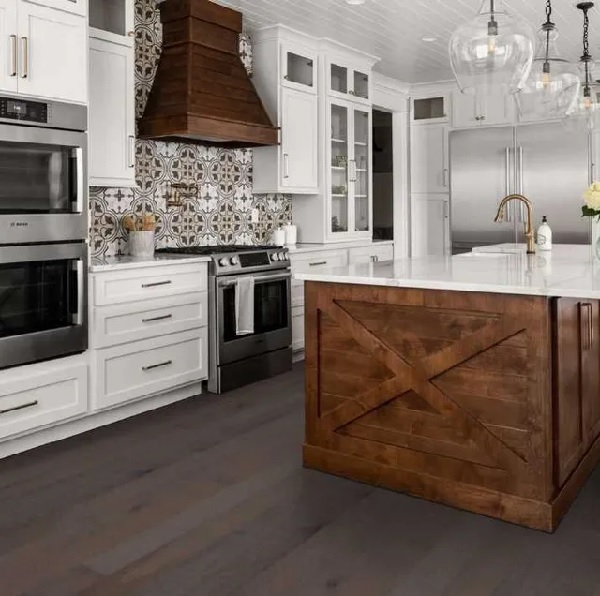 A farmhouse kitchen featuring Shaw Floors Repel hardwood flooring in a hickory dogwood finish 
