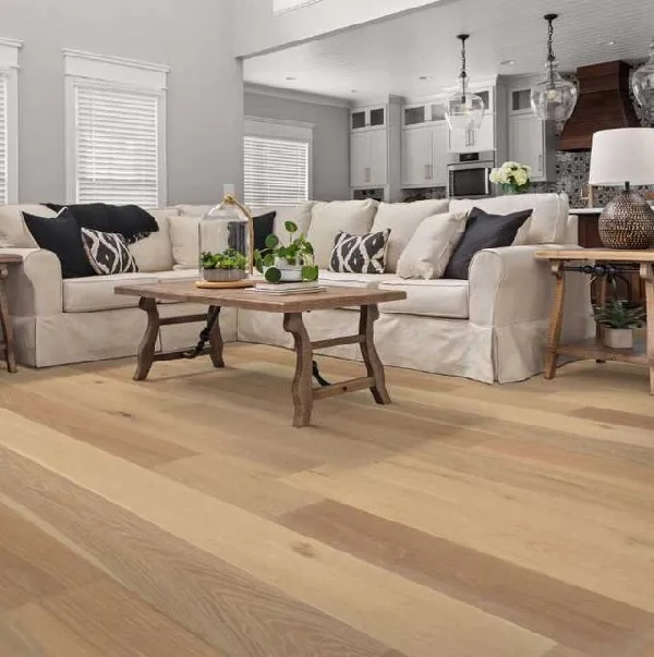 A living room featuring Shaw Floors Floorte hardwood flooring in a exquisite flaxen oak finish 