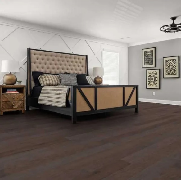 A bedroom featuring Shaw Floors Repel hardwood flooring in a alpine hickory metro brown finish 
