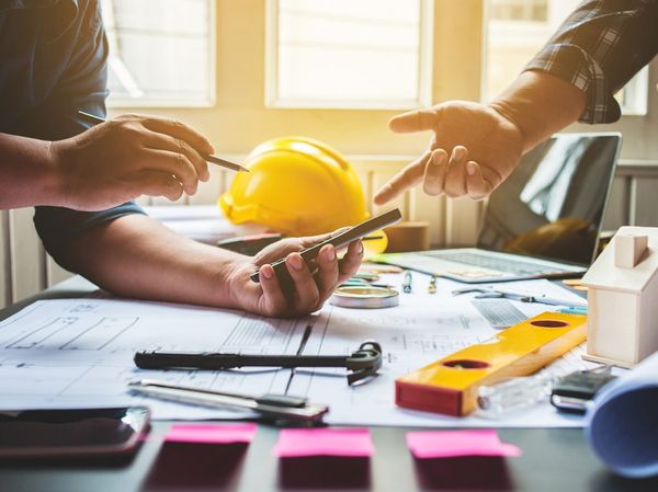 Builder Consulting with Other Worker