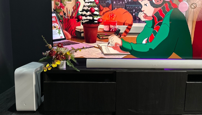 A Sonos soundbar under a TV playing an animated holiday film.