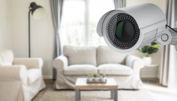 Closeup of wire security camera watching over the living room