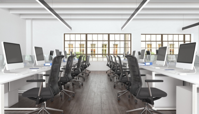 Empty office full of chairs and computers
