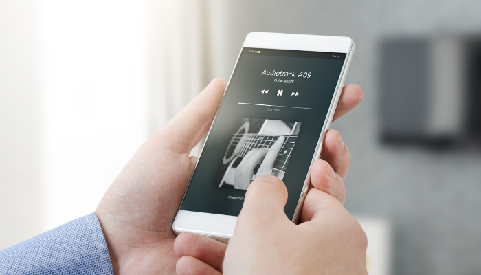 Closeup of phone streaming music to speakers