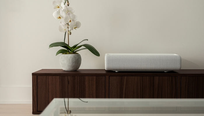 A Samsung short throw projector sitting close to the wall