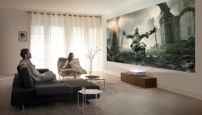 A couple watching something on their Samsung short throw projector