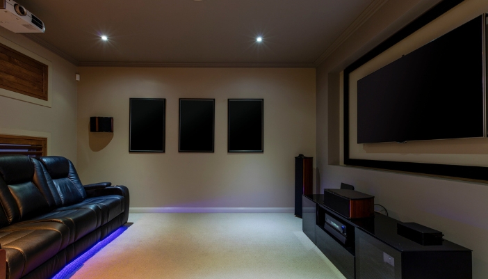 Entry level home theater setup with projector, screen, and speakers
