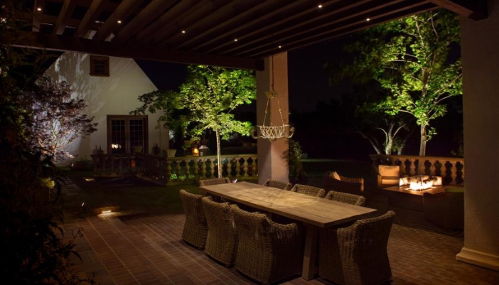 An outdoor patio with many decorative light sources. 