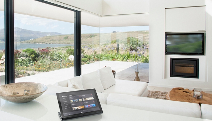 A brightly lit home with white walls and accents and smart home elements.