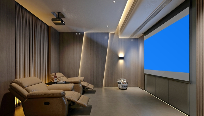 A darkly lit home theater with leather recliners and a projector.