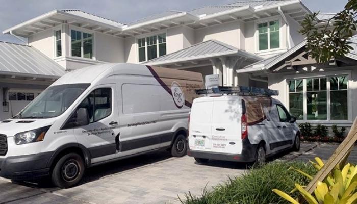 executive electronics technician vehicles parked outside of luxurious home