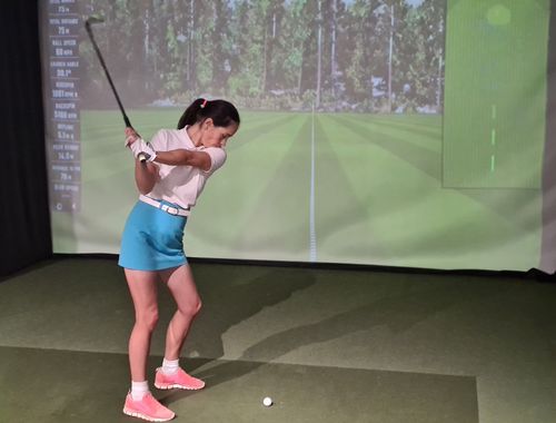 Woman Using a Golf Simulator
