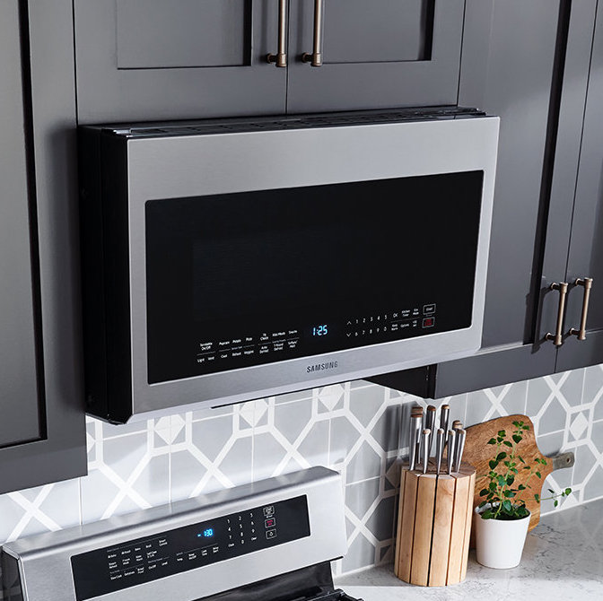 Stainless steel Samsung microwave above a stainless steel range