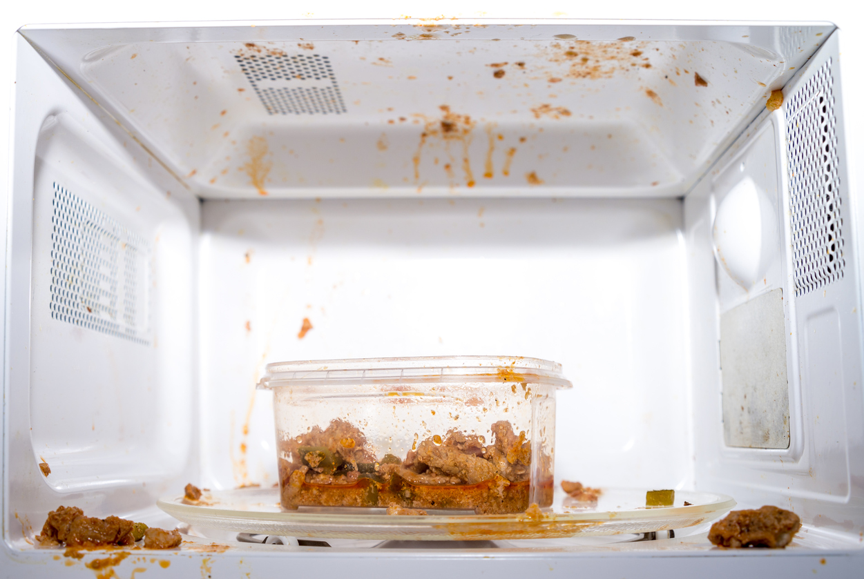 dirty microwave with exploded food inside