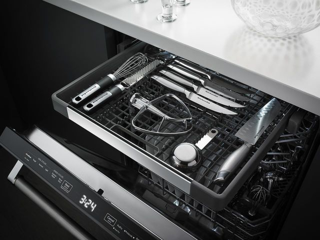 Front view of an opened KitchenAid third rack dishwasher with the drawer pulled out and items on top