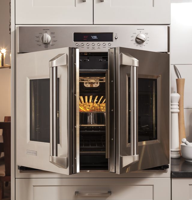 front view of a GE Monogram French door oven with both doors slightly open to reveal a roast in the oven